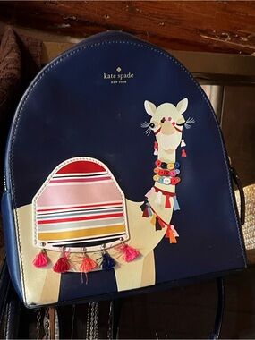 kate spade navy backpack with cream llama and multicolor tassels